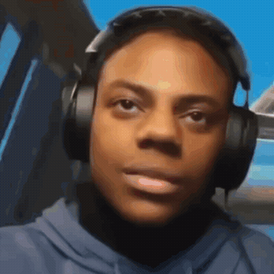 A Man Wearing Headphones Is Looking At The Camera . GIF