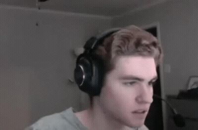 A Man Wearing Headphones Is Looking At The Camera In A Blurry Photo . GIF