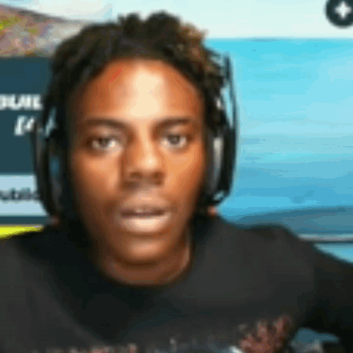 A Man Wearing Headphones Is Looking At The Camera . GIF