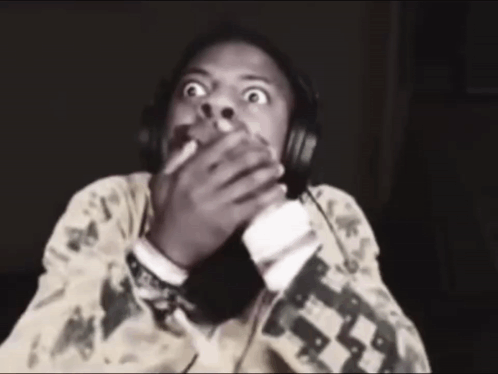 A Man Wearing Headphones Is Making A Funny Face GIF