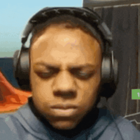A Man Wearing Headphones Is Making A Funny Face . GIF