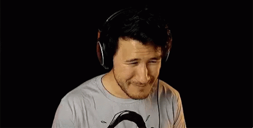 A Man Wearing Headphones Is Making A Funny Face . GIF