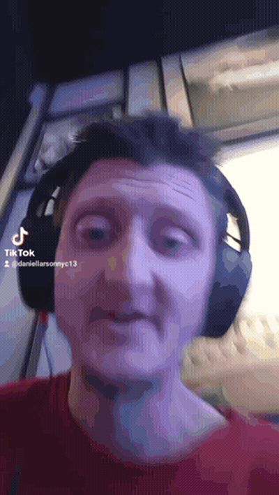 A Man Wearing Headphones Is Making A Funny Face In A Tik Tok Video GIF