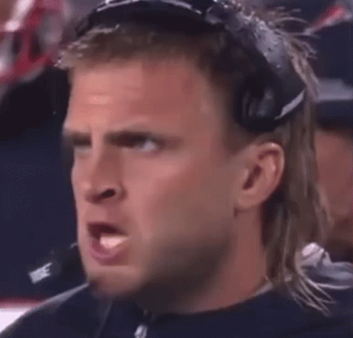 A Man Wearing Headphones Is Making A Funny Face . GIF