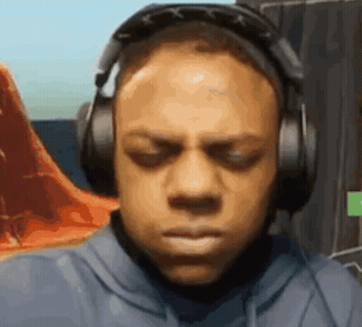 A Man Wearing Headphones Is Making A Funny Face While Playing A Video Game . GIF