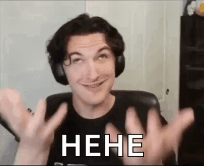 A Man Wearing Headphones Is Making A Funny Face While Sitting In A Chair With His Hands Up . GIF