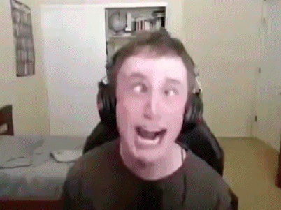 A Man Wearing Headphones Is Making A Funny Face While Sitting In A Gaming Chair . GIF