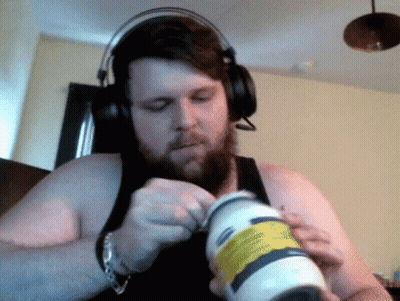 A Man Wearing Headphones Is Opening A Bottle Of Lotion GIF