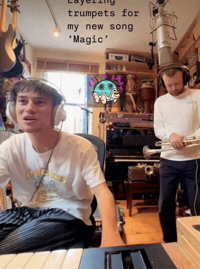 A Man Wearing Headphones Is Playing A Trumpet While Another Man Plays A Piano GIF