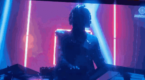 A Man Wearing Headphones Is Playing Music In Front Of A Sign That Says ' Rockstar ' GIF