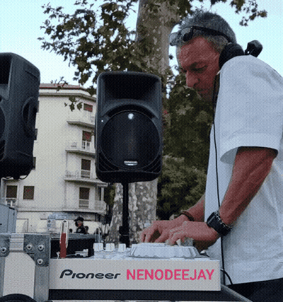 A Man Wearing Headphones Is Playing Music On A Pioneer Nenodeejay Machine GIF