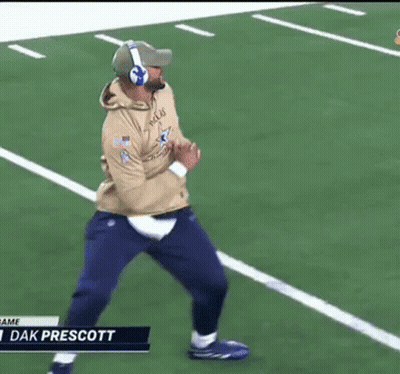 A Man Wearing Headphones Is Running On A Football Field With The Name Dak Prescott At The Bottom GIF