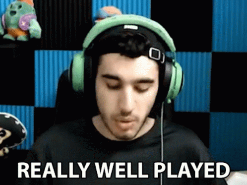 A Man Wearing Headphones Is Saying `` Really Well Played '' While Sitting In A Chair . GIF