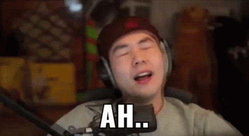 A Man Wearing Headphones Is Singing Into A Microphone And Saying `` Ah '' . GIF