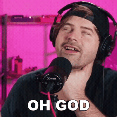 A Man Wearing Headphones Is Singing Into A Microphone And Says Oh God . GIF