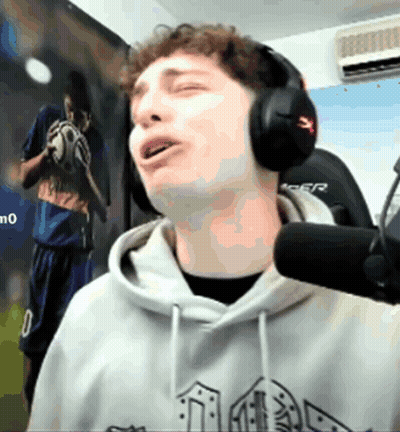 A Man Wearing Headphones Is Singing Into A Microphone In Front Of A Picture Of A Soccer Player Holding A Ball GIF