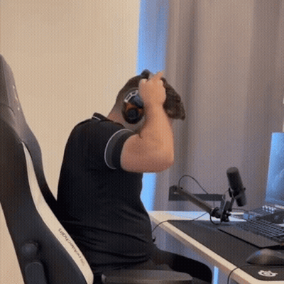 A Man Wearing Headphones Is Sitting In A Black And White Chair GIF