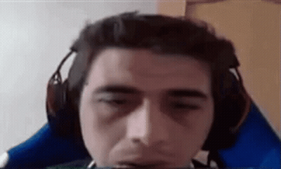 A Man Wearing Headphones Is Sitting In A Blue Chair . GIF