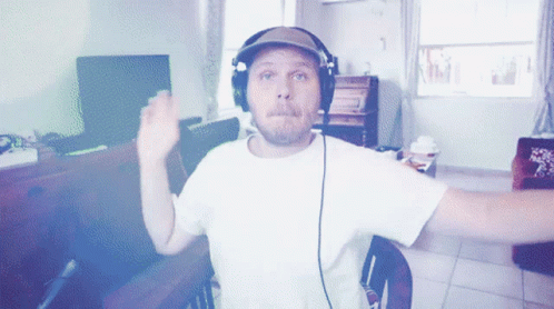 A Man Wearing Headphones Is Sitting In A Chair GIF