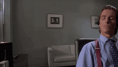A Man Wearing Headphones Is Sitting In A Chair With His Eyes Closed . GIF