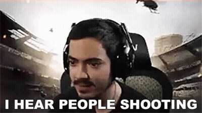 A Man Wearing Headphones Is Sitting In A Chair With The Words `` I Hear People Shooting '' . GIF