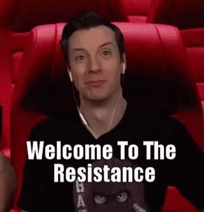 A Man Wearing Headphones Is Sitting In A Red Chair With The Words `` Welcome To The Resistance '' Written On The Screen  GIF