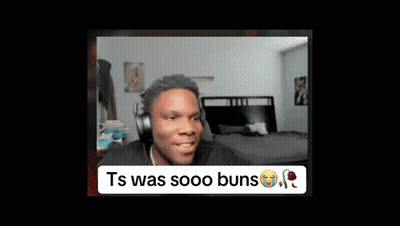 A Man Wearing Headphones Is Sitting In Front Of A Bed In A Room . GIF