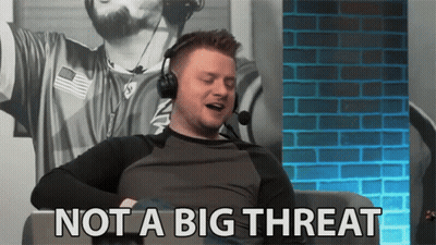 A Man Wearing Headphones Is Sitting In Front Of A Brick Wall And Says Not A Big Threat . GIF