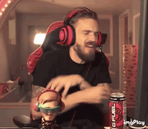 A Man Wearing Headphones Is Sitting In Front Of A Can Of Gfuel Energy Drink GIF