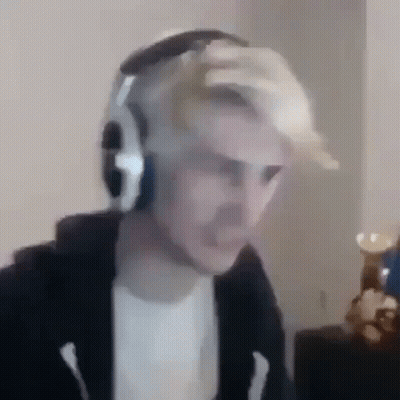 A Man Wearing Headphones Is Sitting In Front Of A Computer Monitor . GIF