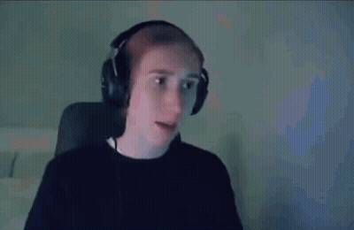 A Man Wearing Headphones Is Sitting In Front Of A Computer Screen . GIF