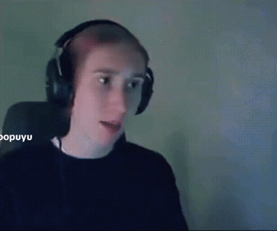 A Man Wearing Headphones Is Sitting In Front Of A Computer Screen . GIF