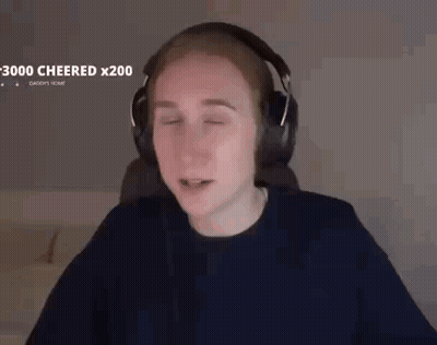 A Man Wearing Headphones Is Sitting In Front Of A Computer With His Eyes Closed . GIF