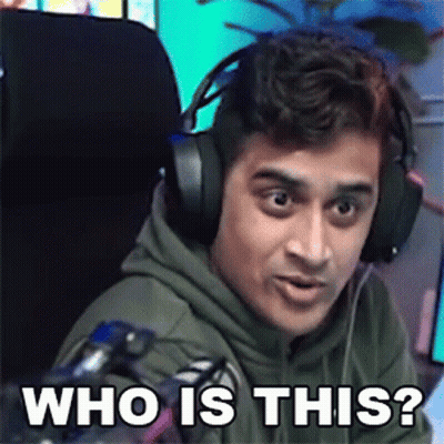 A Man Wearing Headphones Is Sitting In Front Of A Microphone And Making A Funny Face . GIF