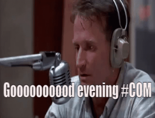 A Man Wearing Headphones Is Sitting In Front Of A Microphone And Saying Good Evening #Com GIF