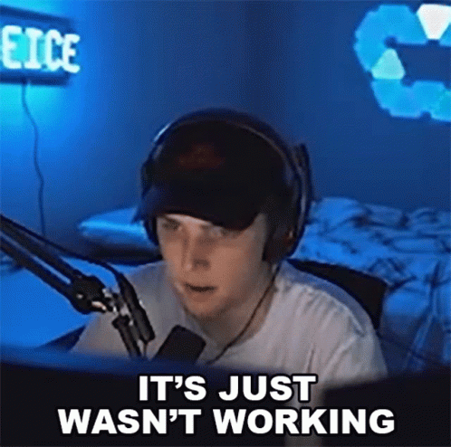 A Man Wearing Headphones Is Sitting In Front Of A Microphone And Saying It 'S Just Wasn 'T Working GIF