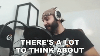 A Man Wearing Headphones Is Sitting In Front Of A Microphone And Saying `` There 'S A Lot To Think About '' GIF