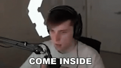 A Man Wearing Headphones Is Sitting In Front Of A Microphone And Says `` Come Inside '' . GIF