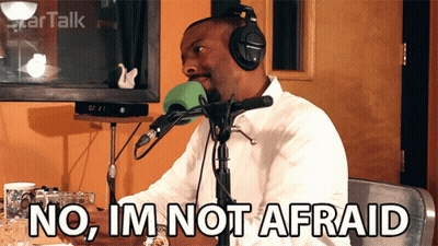 A Man Wearing Headphones Is Sitting In Front Of A Microphone And Says No Im Not Afraid GIF