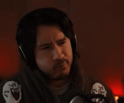 A Man Wearing Headphones Is Sitting In Front Of A Microphone And The Word Pass Is Above Him . GIF