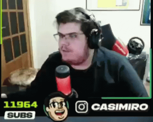 A Man Wearing Headphones Is Sitting In Front Of A Microphone In A Room . GIF
