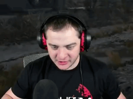 A Man Wearing Headphones Is Sitting In Front Of A Microphone . GIF