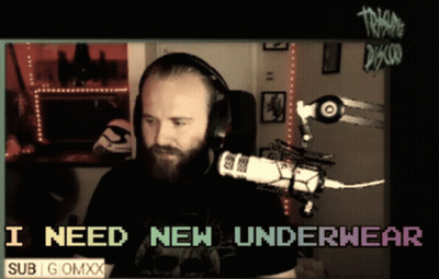 A Man Wearing Headphones Is Sitting In Front Of A Microphone With The Words I Need New Underwear Below Him GIF