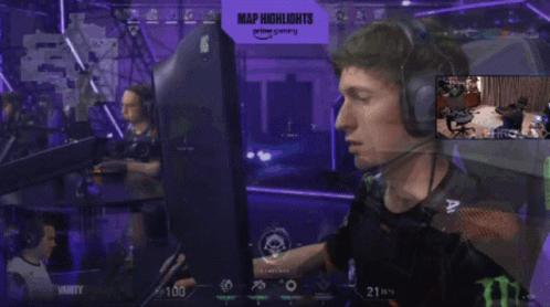 A Man Wearing Headphones Is Sitting In Front Of A Monitor With A Sign That Says Map Highlights On It GIF