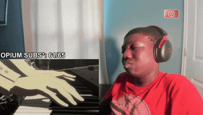 A Man Wearing Headphones Is Sitting In Front Of A Screen That Says " Opium Subs " GIF