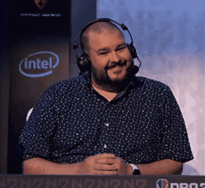 A Man Wearing Headphones Is Sitting In Front Of A Sign That Says Intel GIF