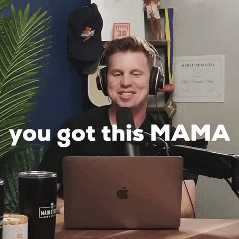 A Man Wearing Headphones Is Sitting In Front Of An Apple Laptop With The Words " You Got This Mama " Behind Him GIF