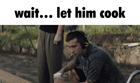 A Man Wearing Headphones Is Sitting On A Bench With A Cup Of Coffee And The Words Wait Let Him Cook Below Him GIF