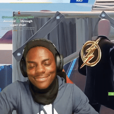 A Man Wearing Headphones Is Smiling In Front Of A Sign That Says ' Donate Through Super Chat ' GIF