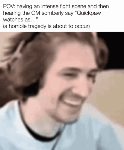 A Man Wearing Headphones Is Smiling While Watching A Video Game . GIF